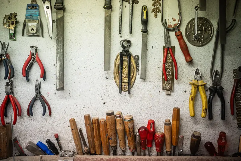 An assortment of hand tools organized in a vintage workshop